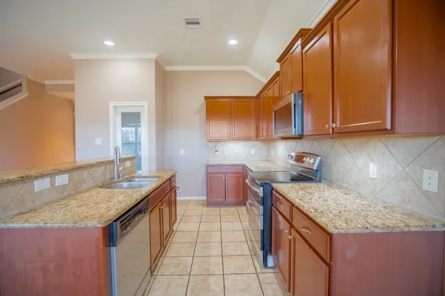 a kitchen with a sink stove and cabinets