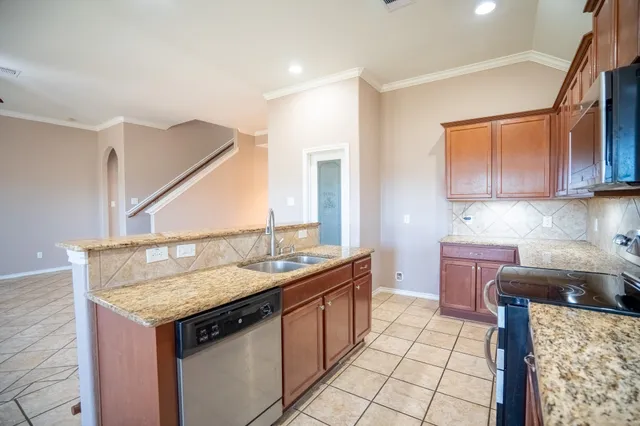 a kitchen with a sink stove and cabinets