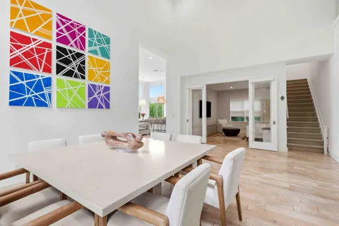 a view of a kitchen with furniture and wooden floor