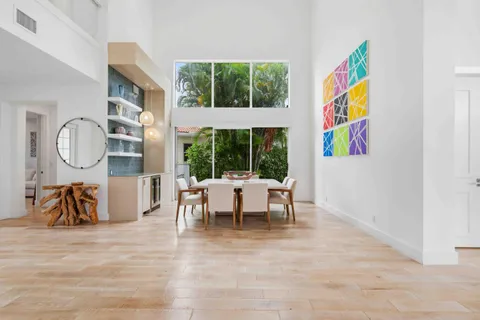 a living room with furniture a fireplace and a kitchen view