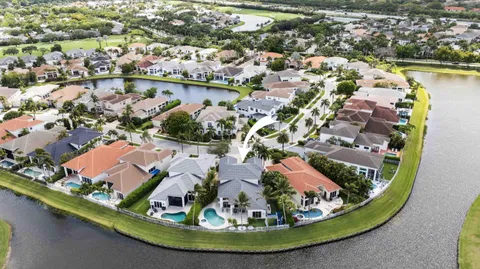 an aerial view of a house with a lake view