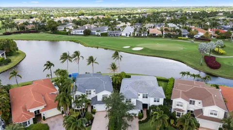 an aerial view of a house with outdoor space and lake view