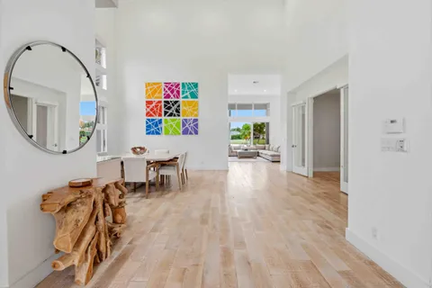 a living room with furniture and a painting on the wall