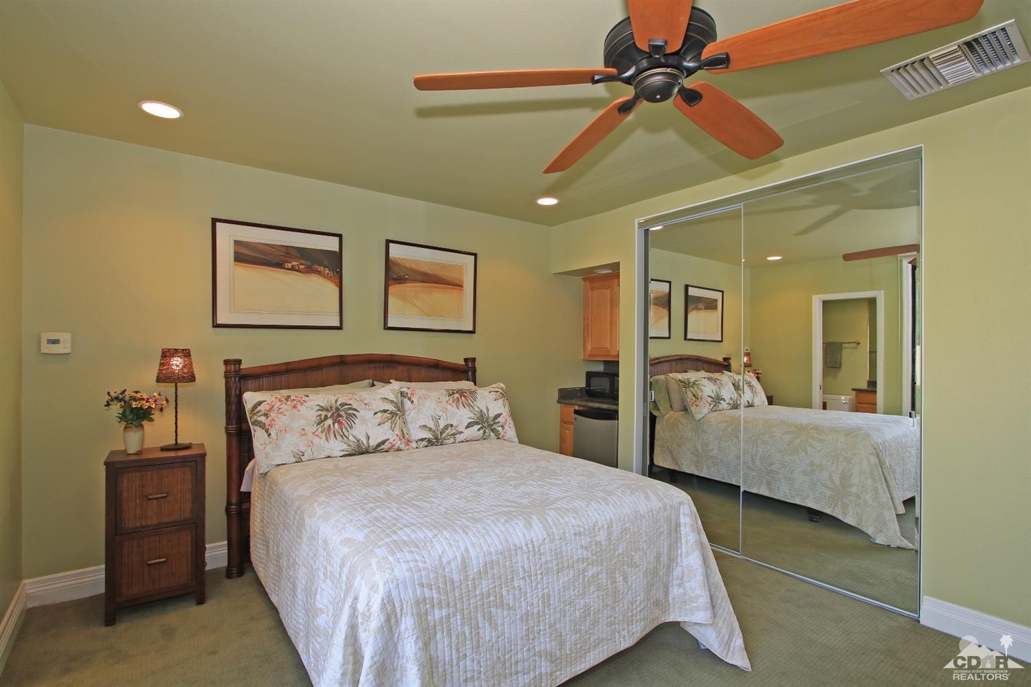 754 Inverness Drive Rancho Mirage, CA 92270 - Photo 22 of 33 a bedroom with a bed and ceiling fan