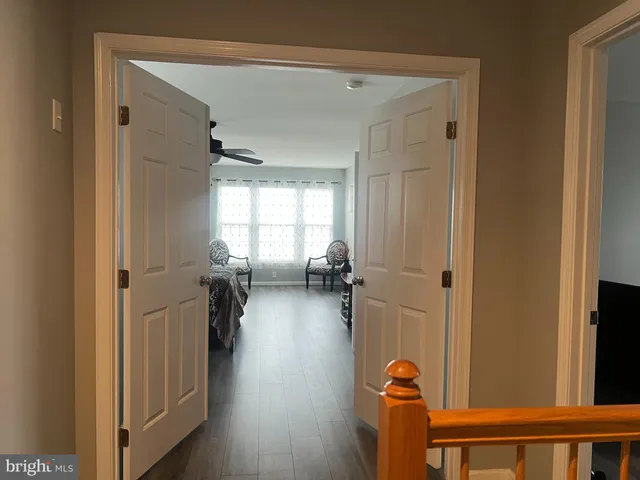 a view of a hallway to a livingroom and a couch