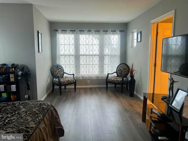 a bedroom with furniture and a window