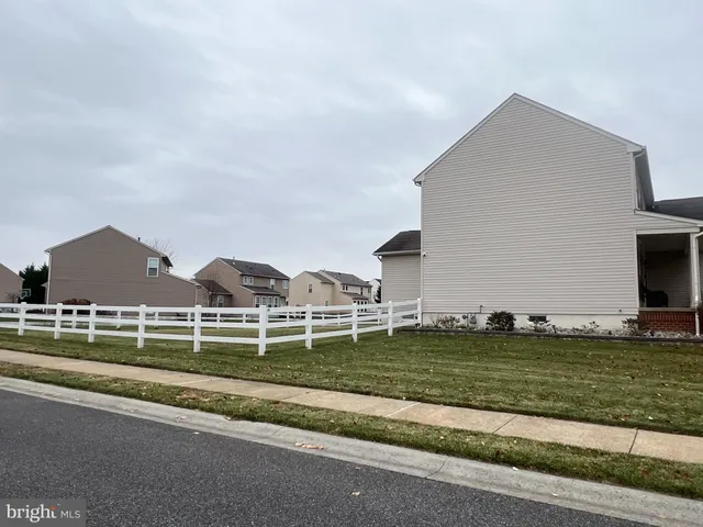 a view of a house with a big yard and potted plants