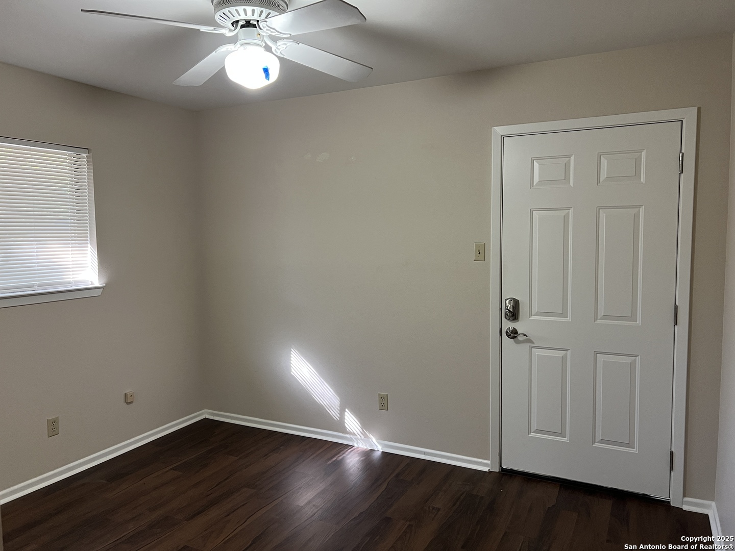 624 East Elm Street, Unit 1 Seguin, TX 78155 - Photo 11 of 19 an empty room with wooden floor closet and windows