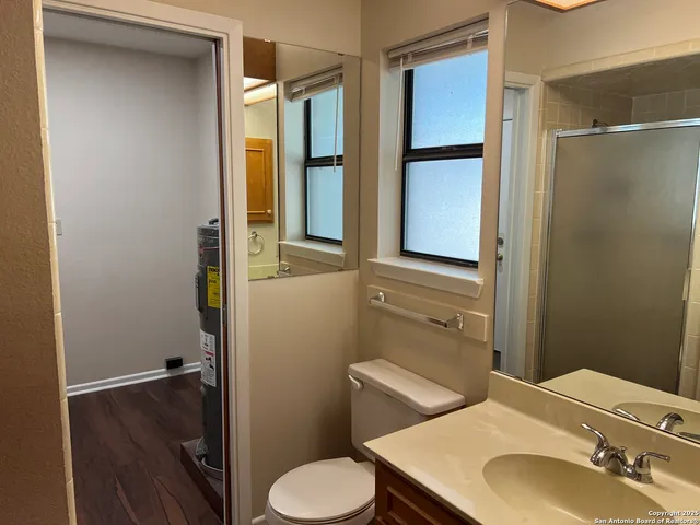 a bathroom with a sink toilet and shower