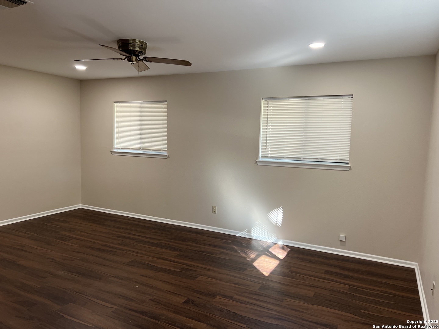 624 East Elm Street, Unit 1 Seguin, TX 78155 - Photo 5 of 19 a view of empty room with wooden floor and fan