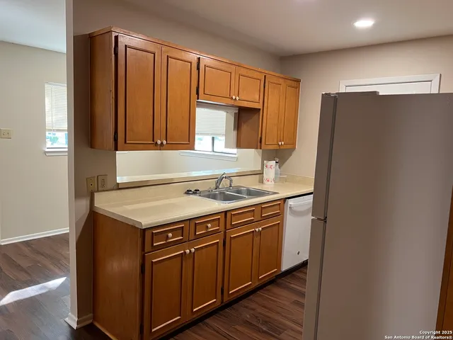 a kitchen with stainless steel appliances granite countertop a refrigerator and a sink