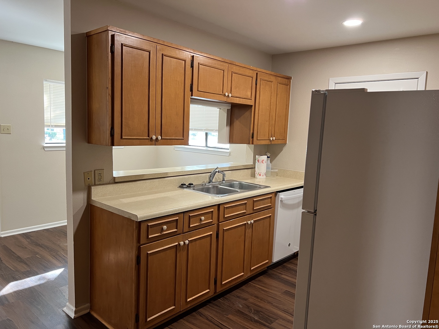 624 East Elm Street, Unit 1 Seguin, TX 78155 - Photo 7 of 19 a kitchen with stainless steel appliances granite countertop a refrigerator and a sink
