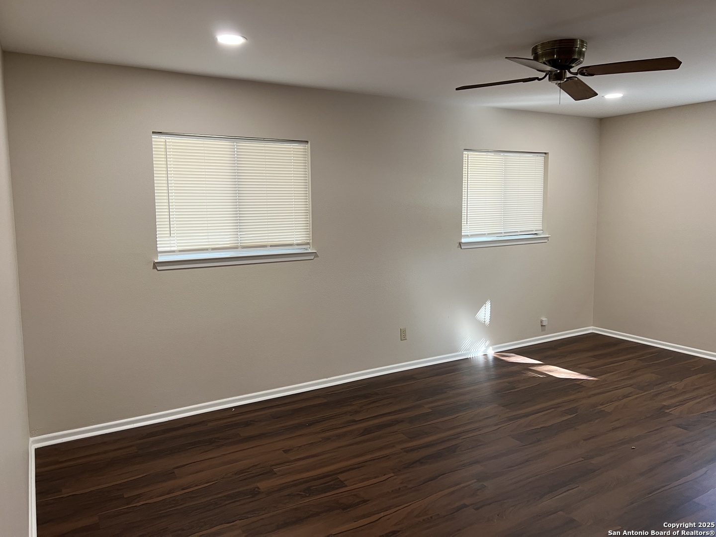 624 East Elm Street, Unit 1 Seguin, TX 78155 - Photo 9 of 19 a view of an empty room with wooden floor and a window