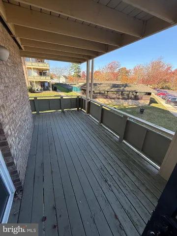 a view of a balcony with wooden floor
