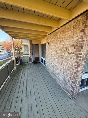 a view of outdoor space with wooden floor and seating