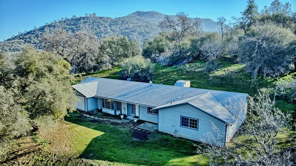 a view of a house with a backyard