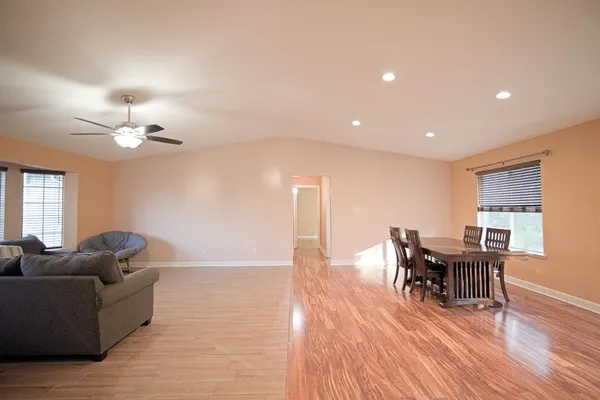 a living room with furniture and wooden floor