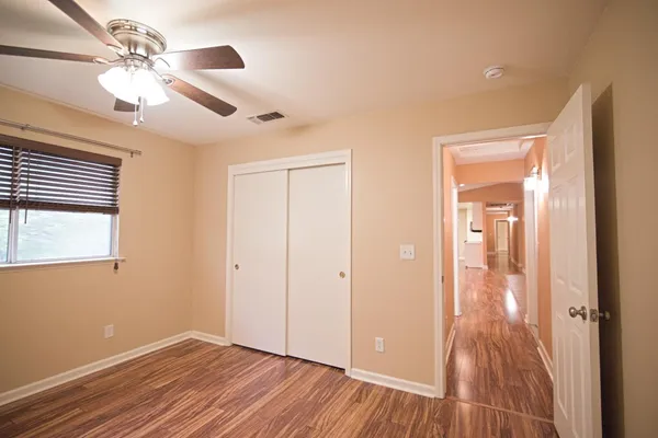 a view of a a dining room with furniture window and wooden floor