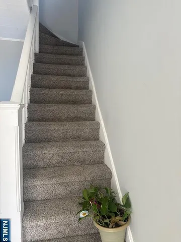 a view of staircase with white walls
