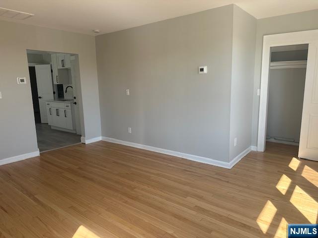 6 Pleasant Avenue, Unit 2 Clifton, NJ 07013 - Photo 2 of 14 a view of a room with wooden floor and bathroom
