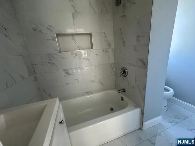a bathroom with a bathtub and a toilet