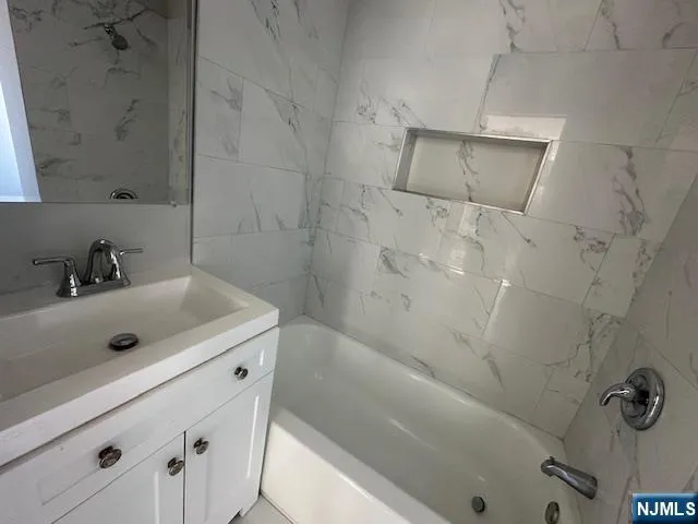 a bathroom with a sink and shower
