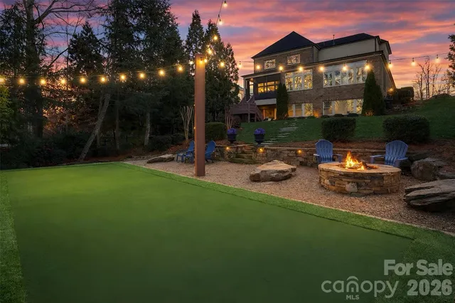 a dining room with furniture a chandelier and wooden floor