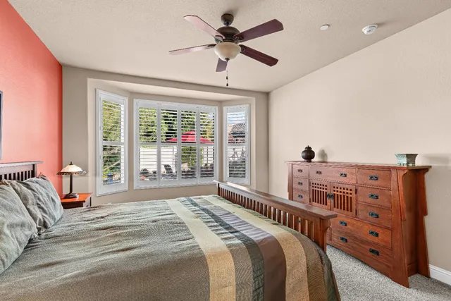 a en suite bathroom with a granite countertop sink mirror and shower