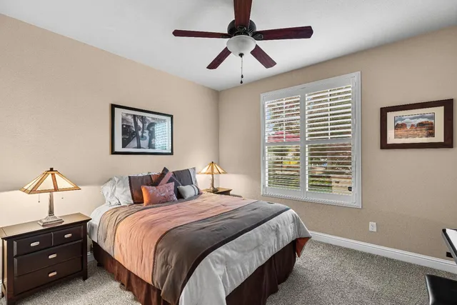 a view of a patio with a dining table and chairs under an umbrella