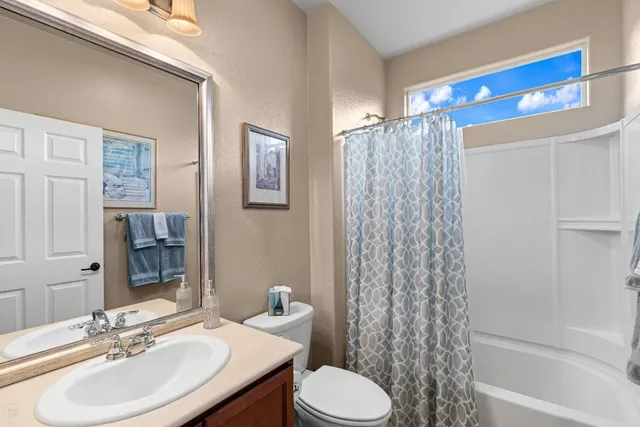 a roof deck with table and chairs under an umbrella