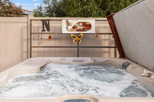 a sign that is sitting in front of a lake with a big yard