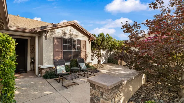 a view of a patio with table and chairs and potted plants