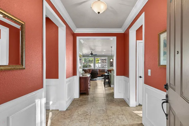 a view of a hallway with living room and furniture