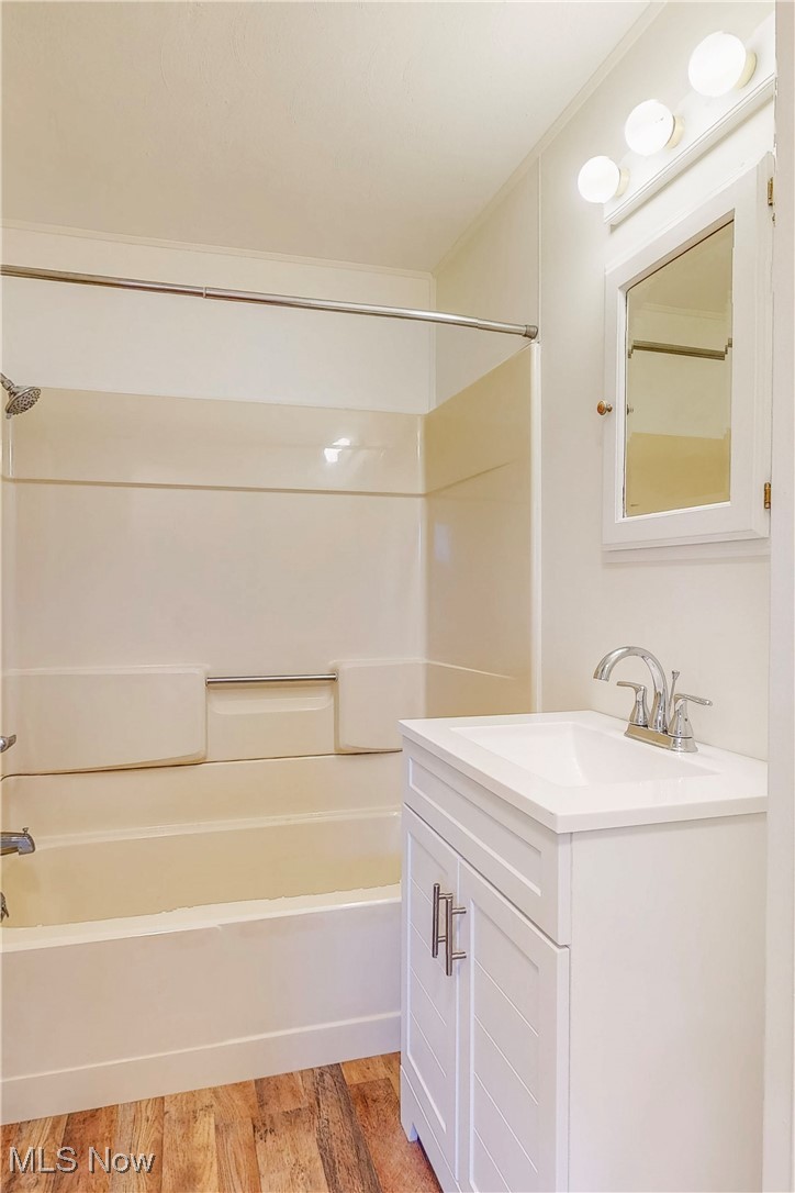 1723 Bantam Ridge Road Steubenville, OH 43953 - Photo 12 of 22 Bathroom with bathtub / shower combination, wood finished floors, and vanity