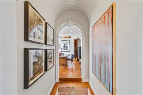 a large dining hall with stainless steel appliances granite countertop a table and chairs in it