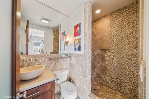 a living room with lots of furniture and kitchen view