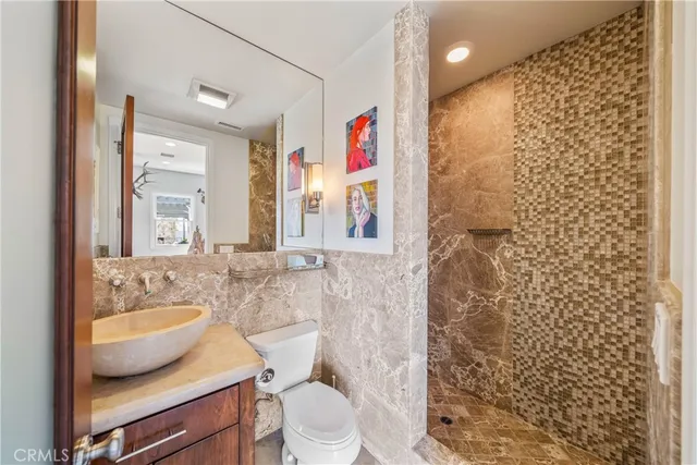a living room with lots of furniture and kitchen view