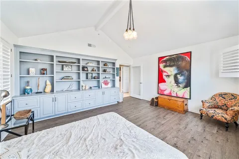 a front view of a building with a garden and plants