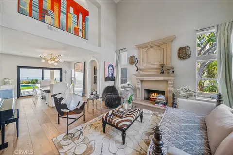 a living room with lots of furniture and kitchen view