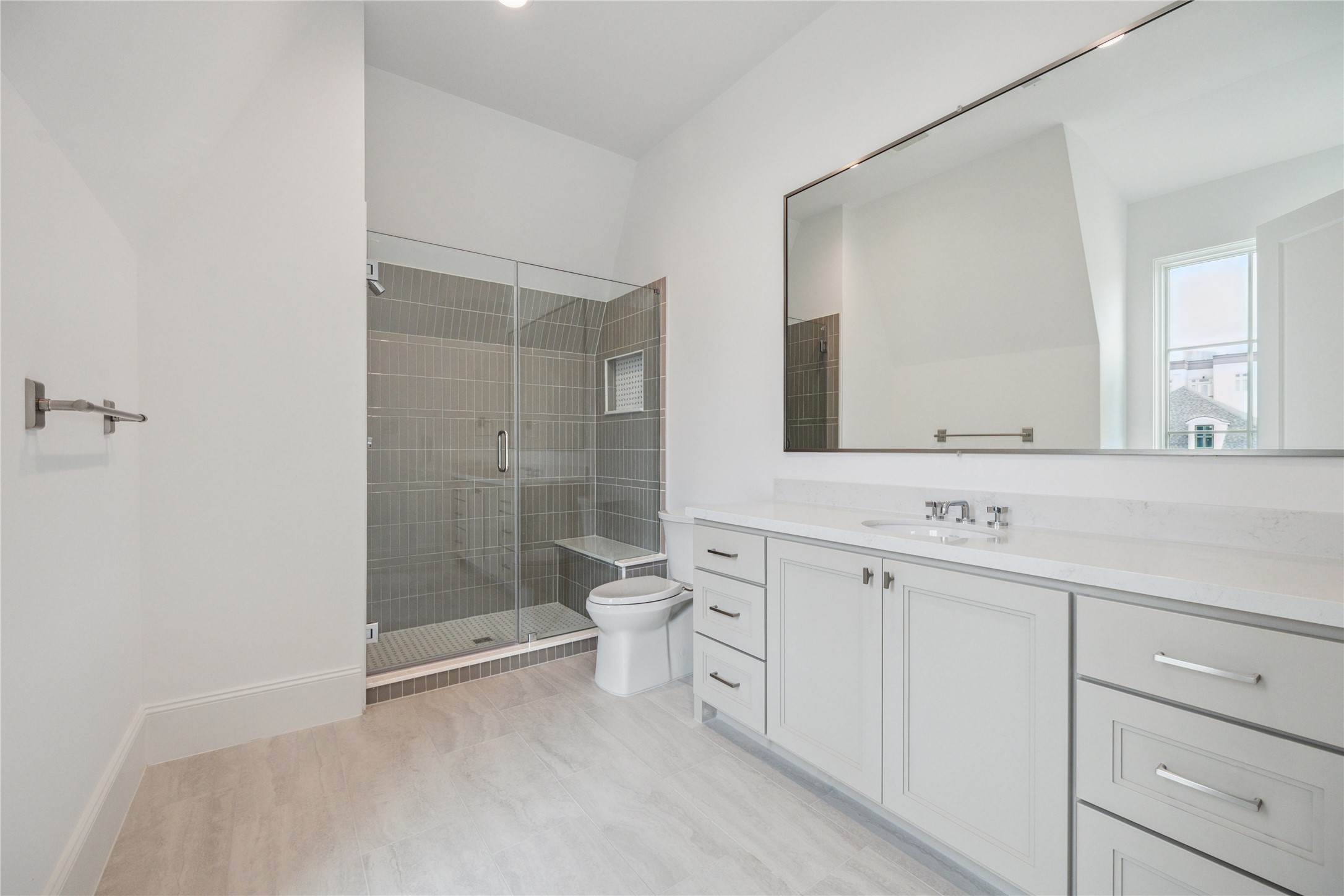 7 Wentworth Gate Path Houston, TX 77027 - Photo 37 of 42 Oversized bathroom to feature glass-framed walk-in shower, expansive mirror, and excess storage and counter space. **Photo is of another home in the community and for information purposes only. Buyer to verify all details.**