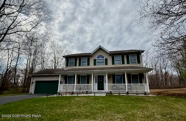 a front view of house with yard and green space