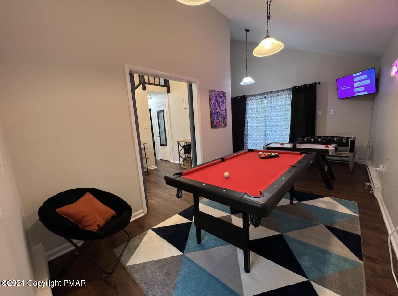 a room with furniture pool table and windows