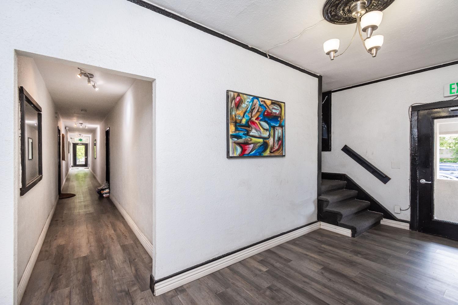 2226 Sutterville Road Sacramento, CA 95822 - Photo 12 of 13 a view of a hallway with wooden floor and stairs