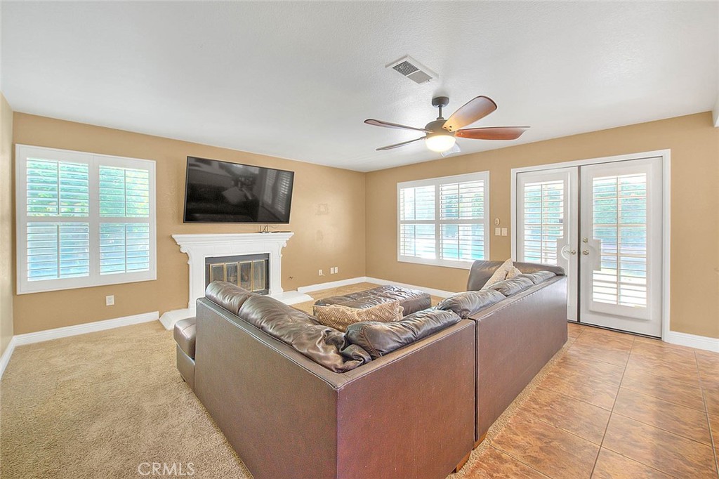 28832 Harwick Drive Highland, CA 92346 - Photo 14 of 62 a living room with fireplace furniture and a flat screen tv