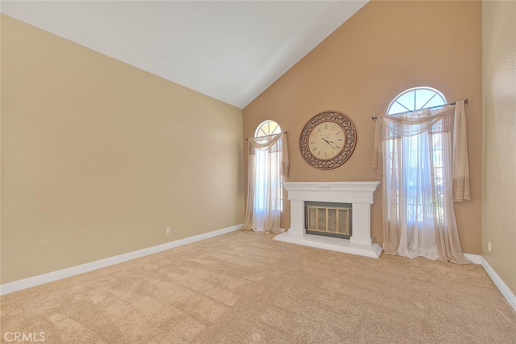 28832 Harwick Drive Highland, CA 92346 - Photo 18 of 62 a living room with a fireplace furniture and a large window