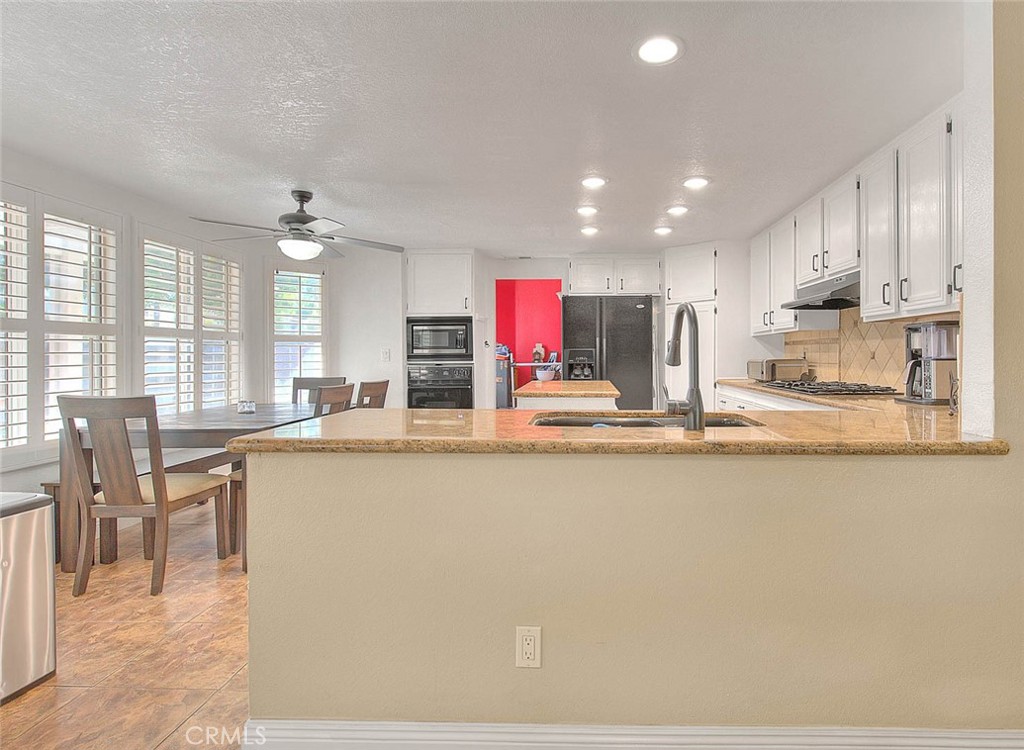 28832 Harwick Drive Highland, CA 92346 - Photo 20 of 62 a large kitchen with stainless steel appliances kitchen island granite countertop a large counter top and a stove top oven