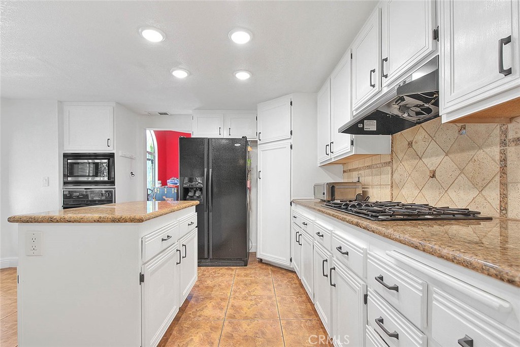 28832 Harwick Drive Highland, CA 92346 - Photo 21 of 62 a kitchen with stainless steel appliances granite countertop a refrigerator a stove a sink and a refrigerator