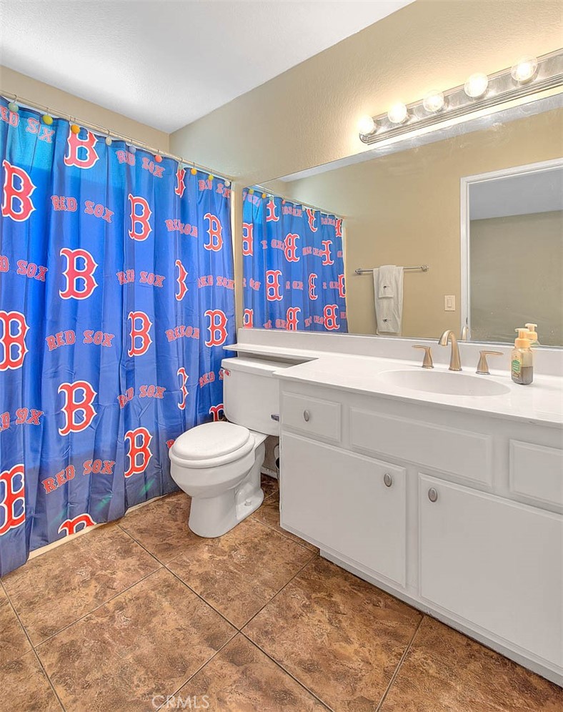 28832 Harwick Drive Highland, CA 92346 - Photo 30 of 62 a bathroom with a toilet sink and mirror