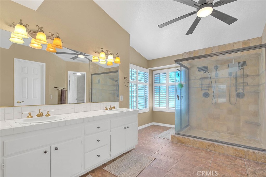 28832 Harwick Drive Highland, CA 92346 - Photo 40 of 62 a spacious bathroom with a double vanity sink a large mirror and a shower
