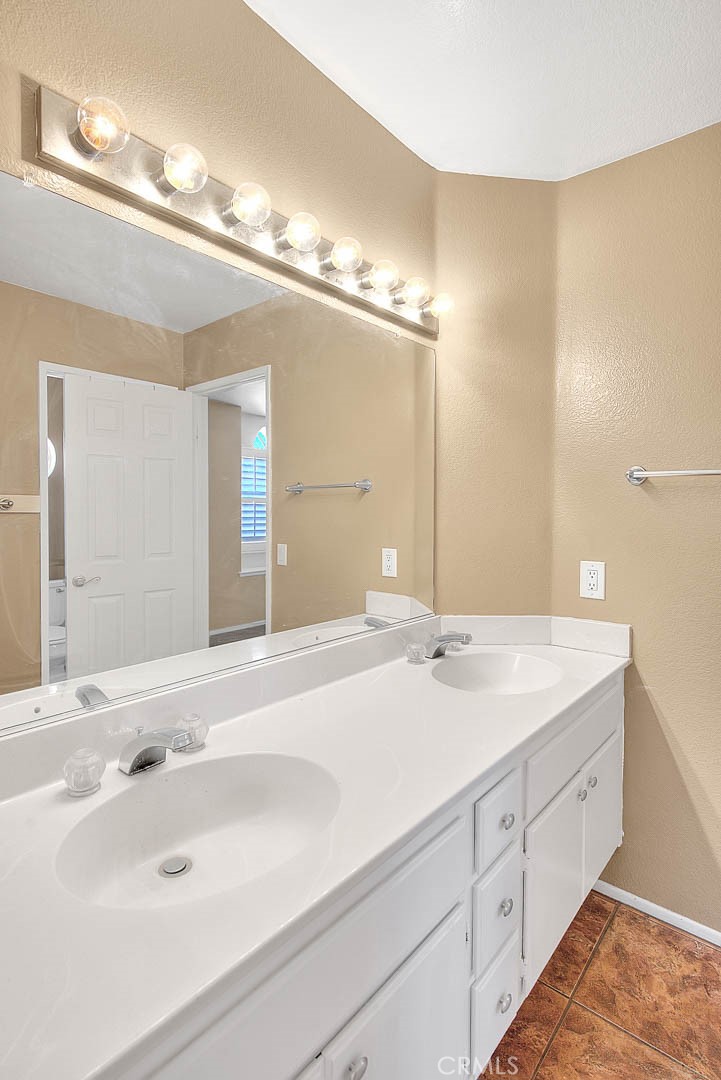 28832 Harwick Drive Highland, CA 92346 - Photo 46 of 62 a bathroom with a sink and a mirror